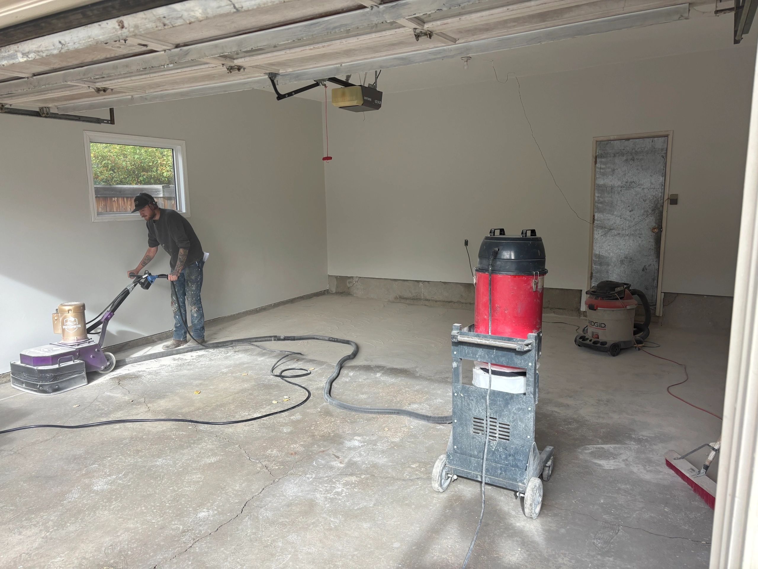 EpoxyEmpireYeg team grinding concrete in Edmonton garage
